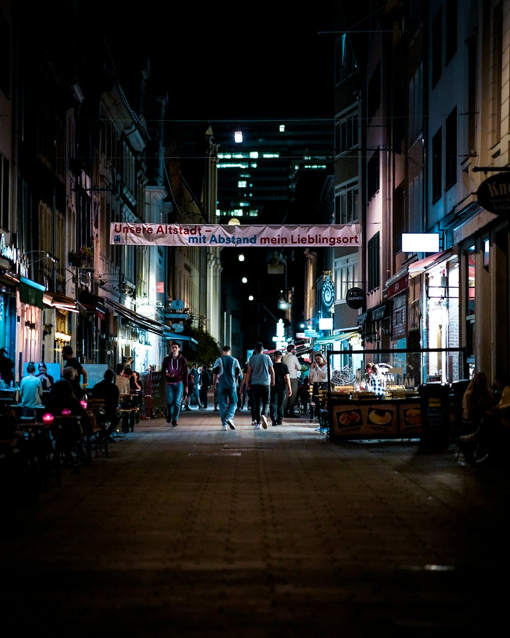 people walking on street during night time