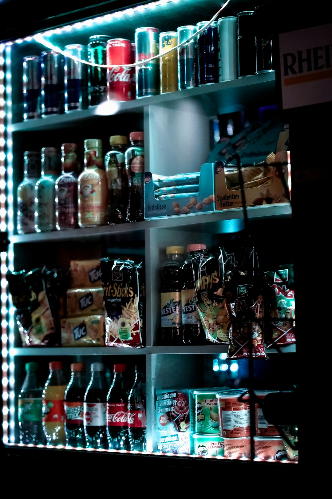 bottles on shelf with lights turned on during night time