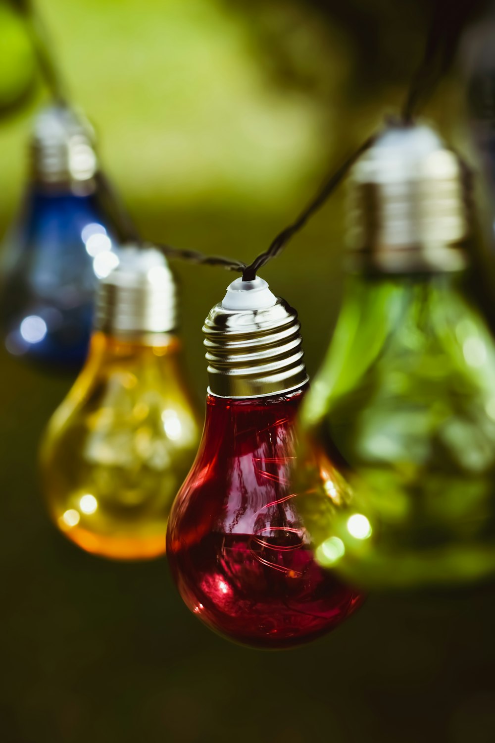 three red and green glass bottles