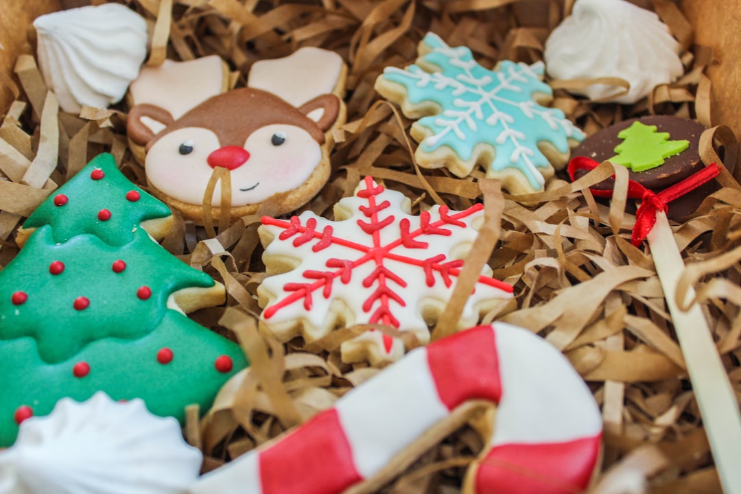 red and white snowman ornament on brown dried leaves,