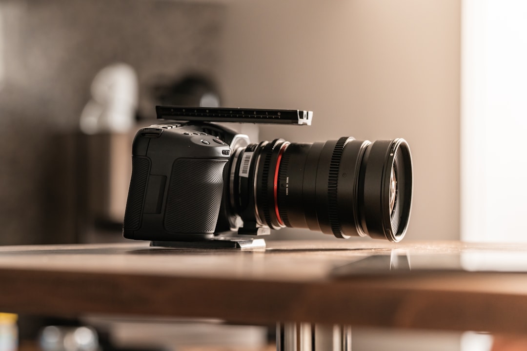 black nikon dslr camera on brown wooden table