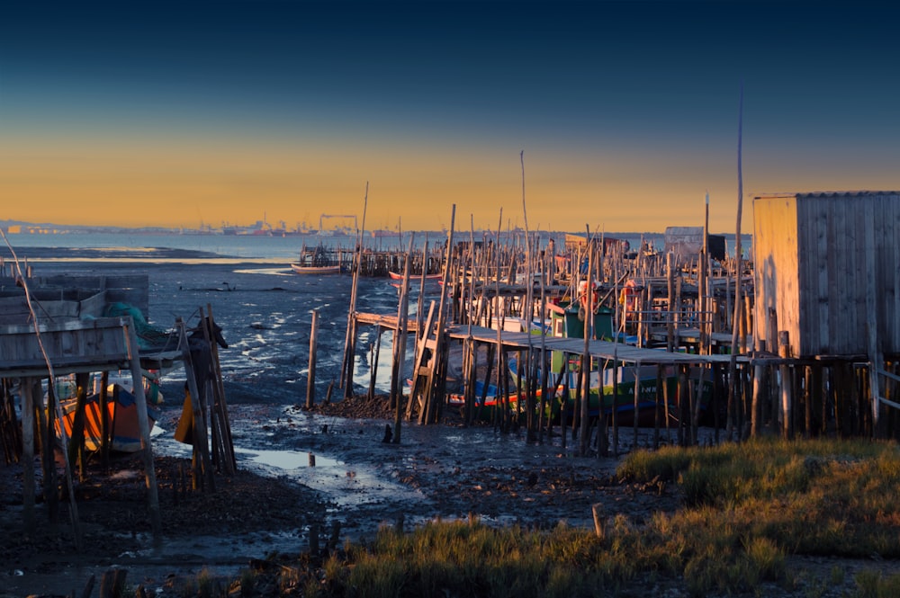 brown wooden dock on sea during sunset