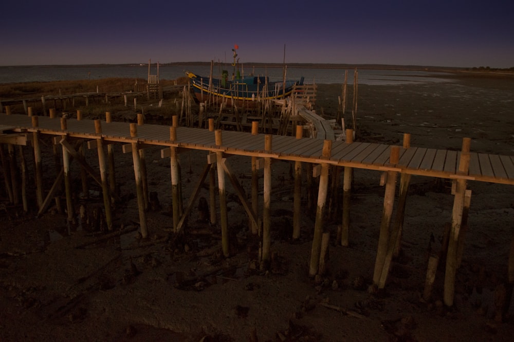 brown wooden dock on beach during daytime