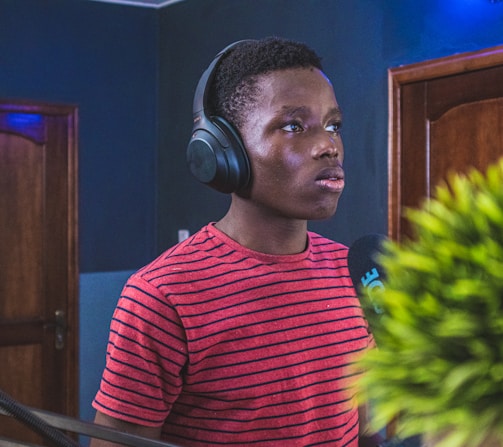 man in red and black striped crew neck shirt wearing headphones