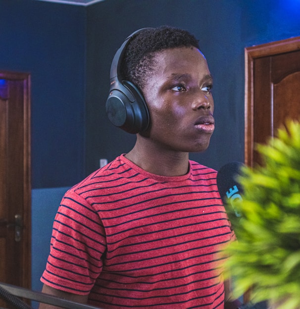 man in red and black striped crew neck shirt wearing headphones