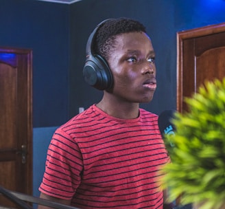 man in red and black striped crew neck shirt wearing headphones