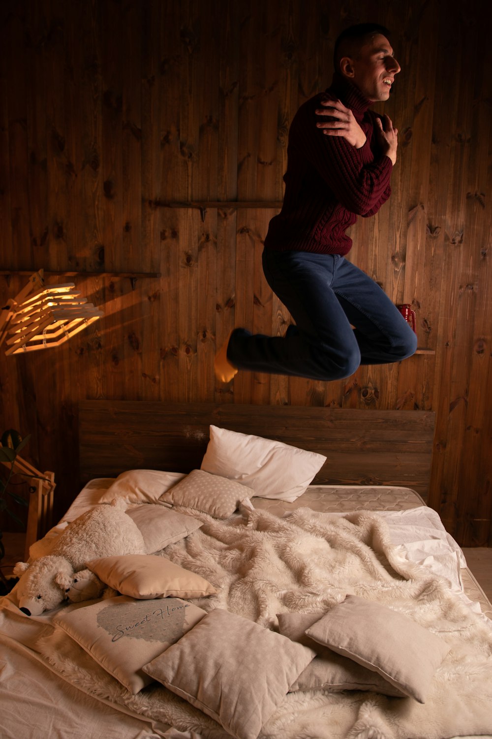 person in blue denim jeans sitting on bed