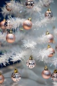 Close-up of sparkling golden decorations with soft pink accents.