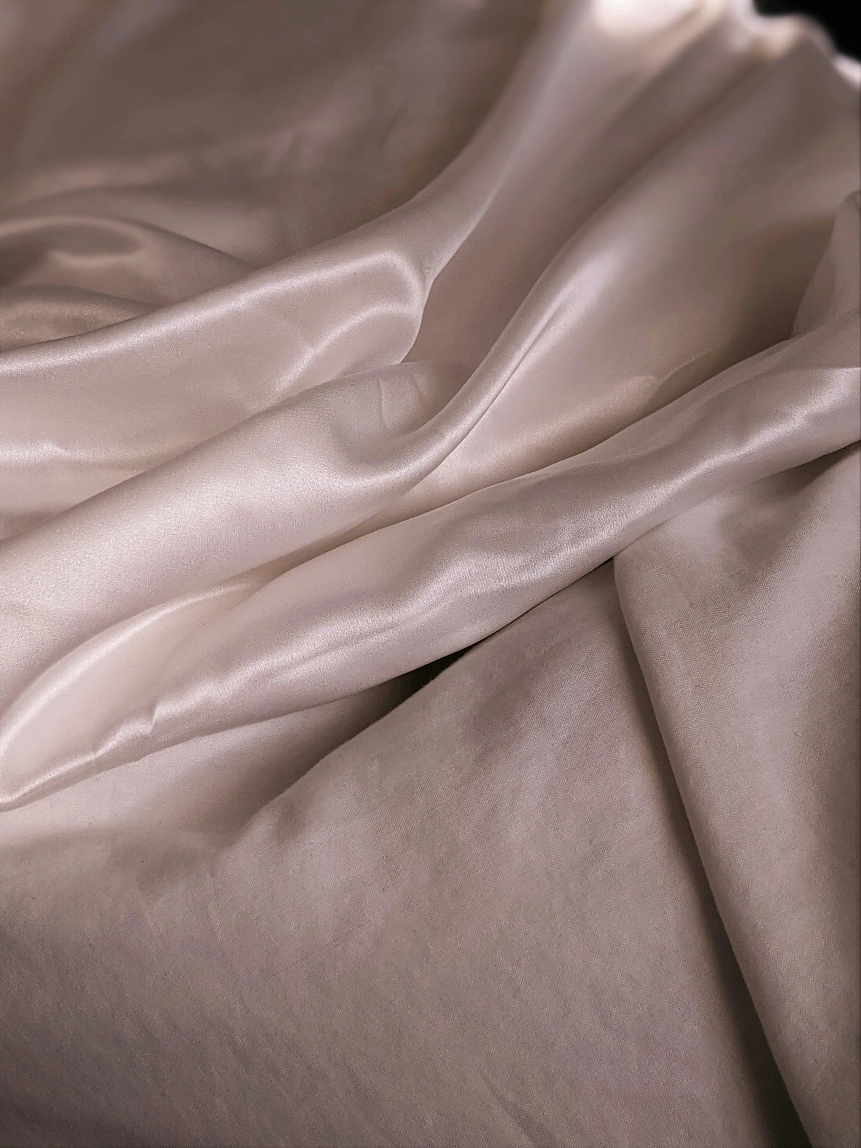 white textile on brown wooden table