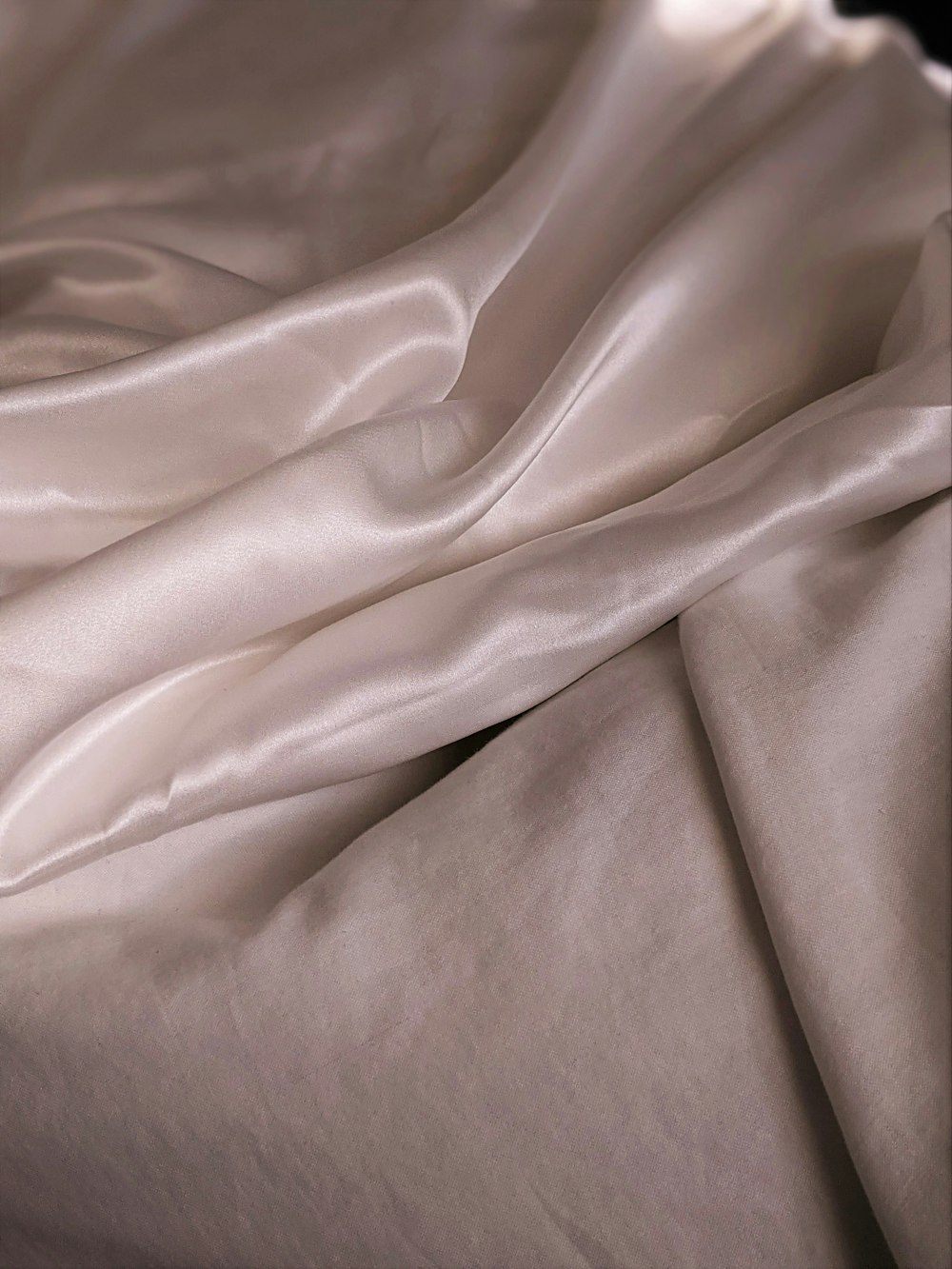 white textile on brown wooden table