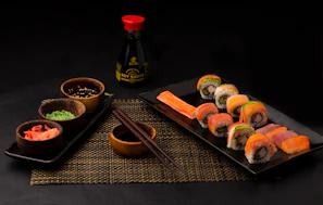 A close-up of a colorful sushi platter arranged artfully on a wooden table.