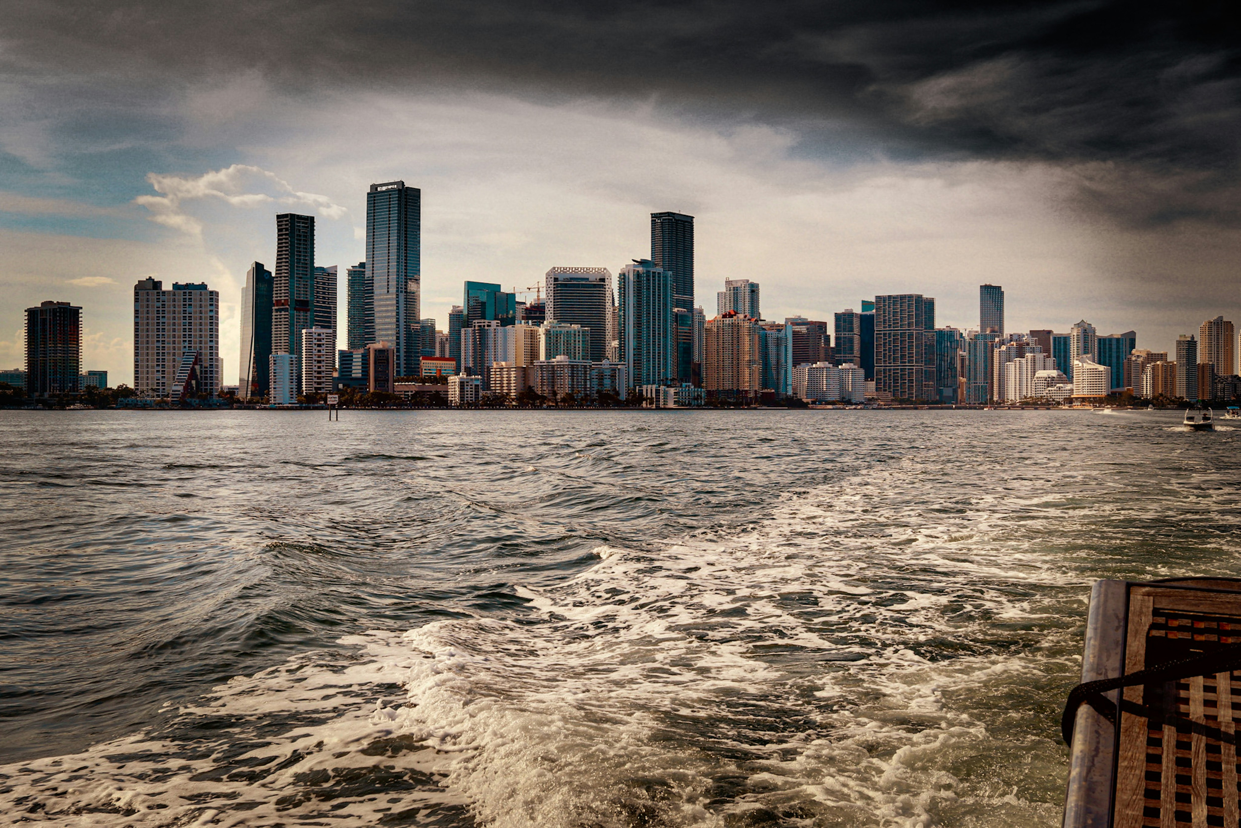 Downtown Miami skyline seen from a boat on Biscayne Bay, with the wake in the foreground
