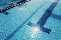 person in swimming pool during daytime
