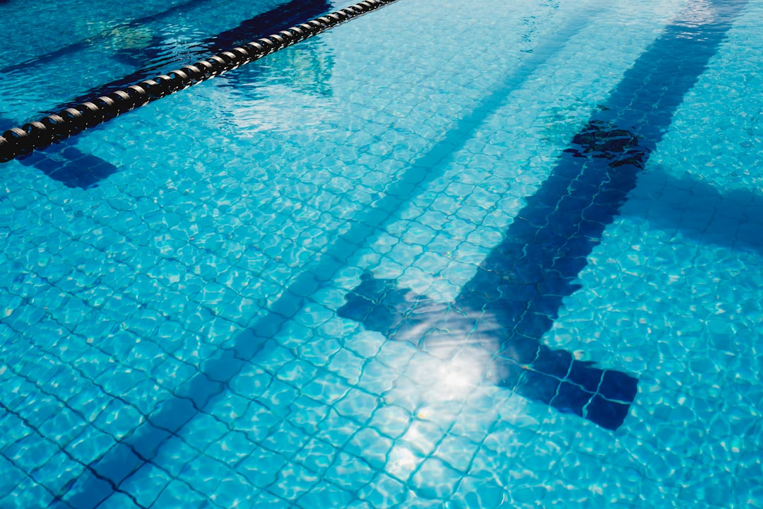 person in swimming pool during daytime