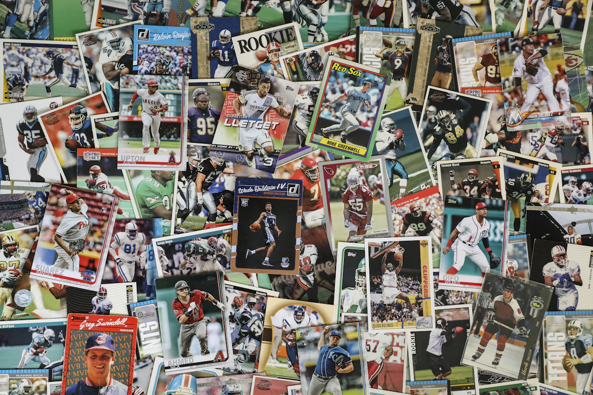 Assorted trading cards laid out neatly on a white surface, mid-sort