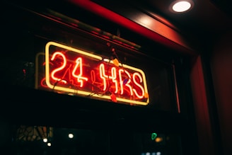 a neon sign that reads 24 hours on it