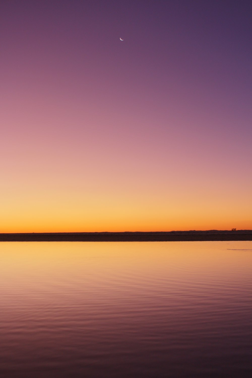 calm sea under orange sky during sunset