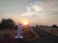 A sunset view over a peaceful countryside road with the tour bus driving along.