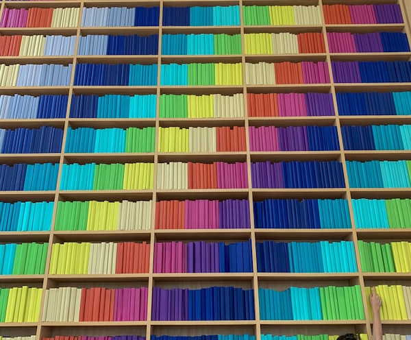 person in black pants walking on multi colored stairs