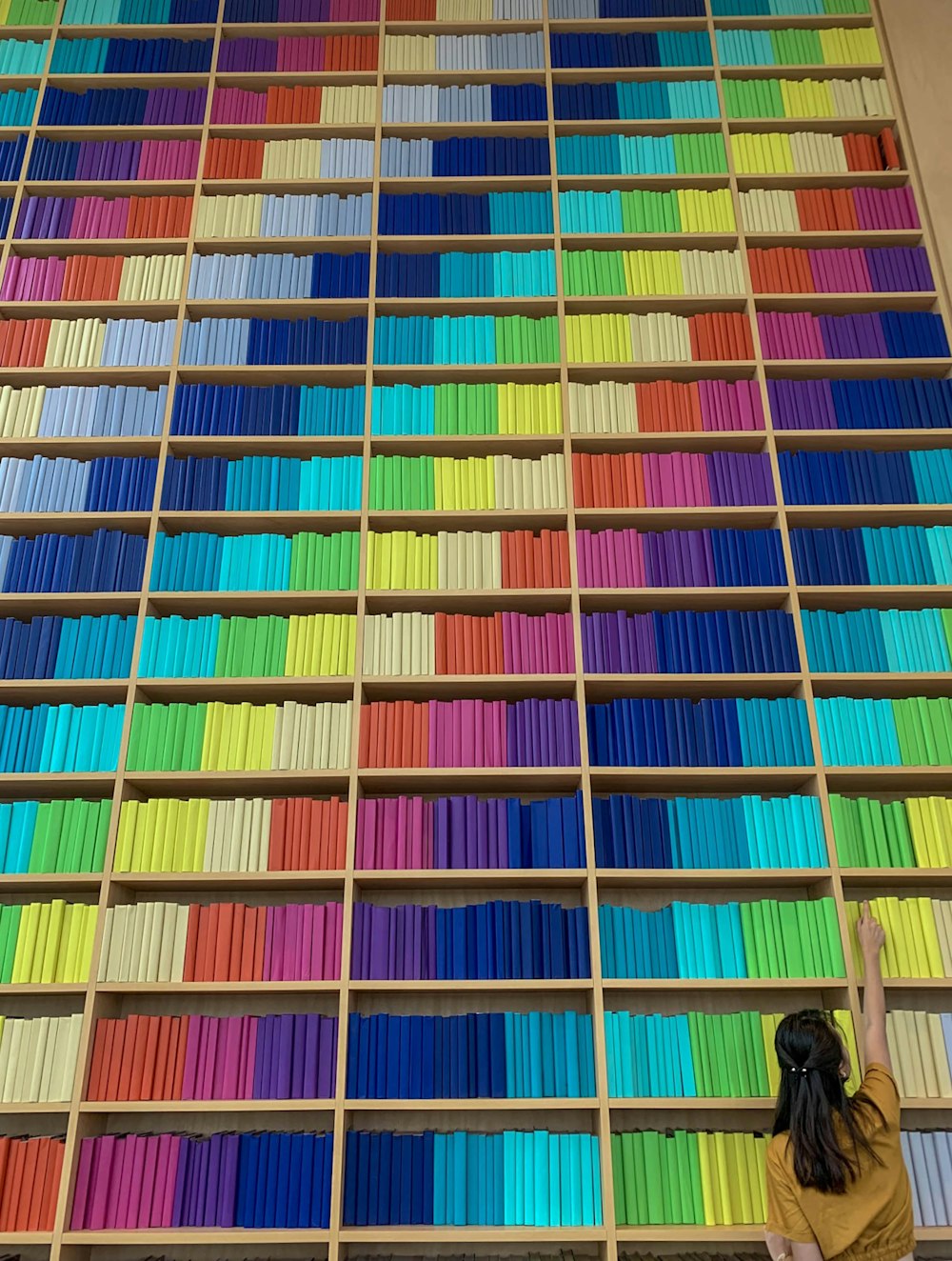 person in black pants walking on multi colored stairs