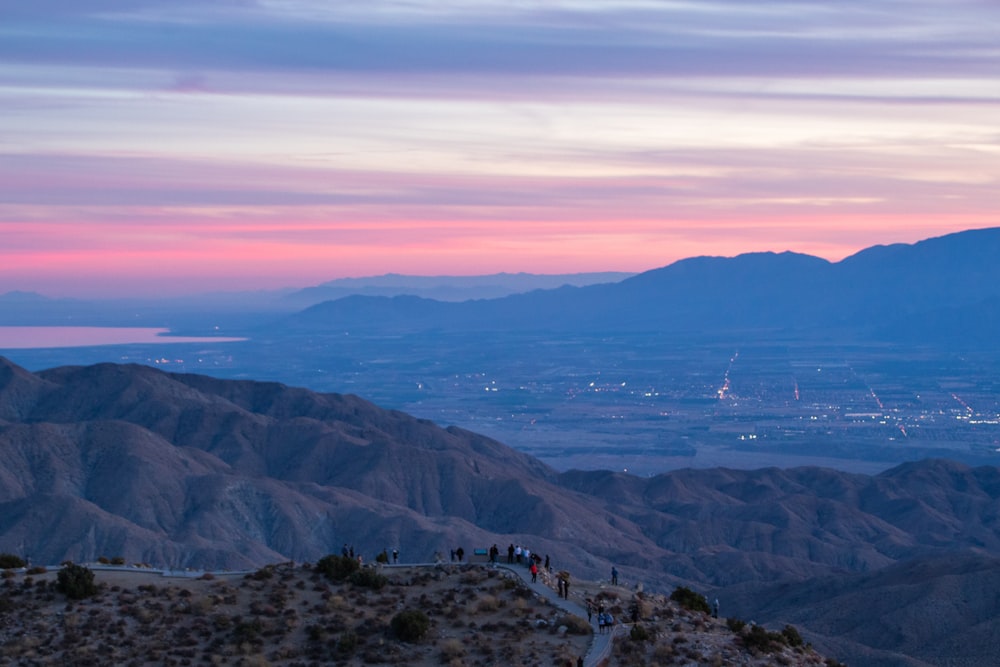 people walking on brown rocky mountain during daytime