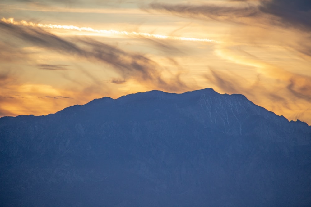 black mountains under white clouds during daytime