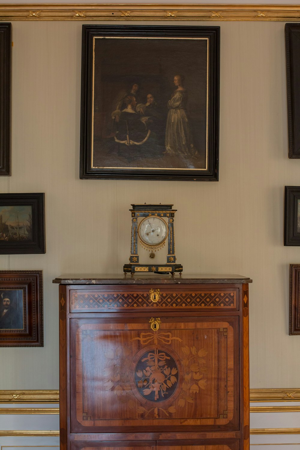 a wooden cabinet with a clock on top of it
