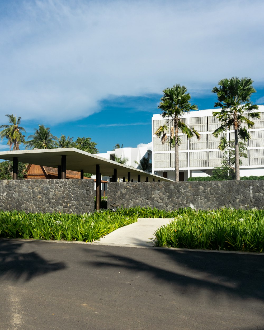 white concrete building near green grass field under blue sky during daytime