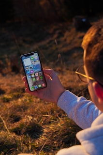person holding black iphone 5