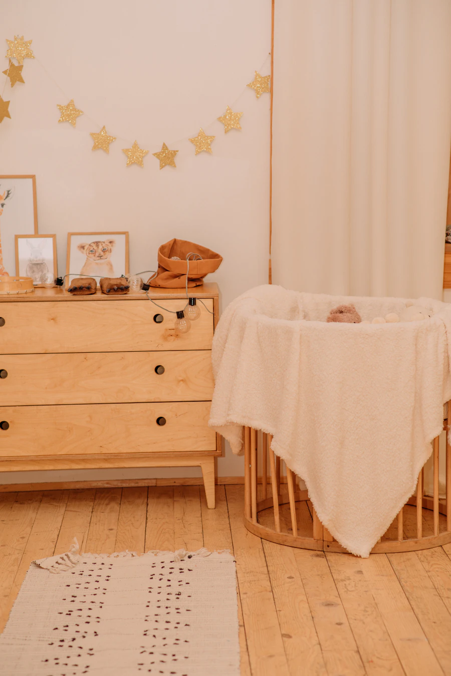 A warm, softly-lit nursery with a wooden crib.