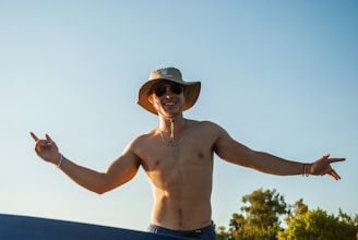 A happy customer wearing a minimaltees shirt outdoors, smiling with natural sunlight.