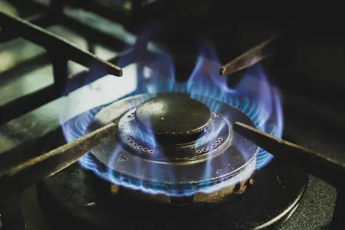 Gas range with blue flame burners in a kitchen