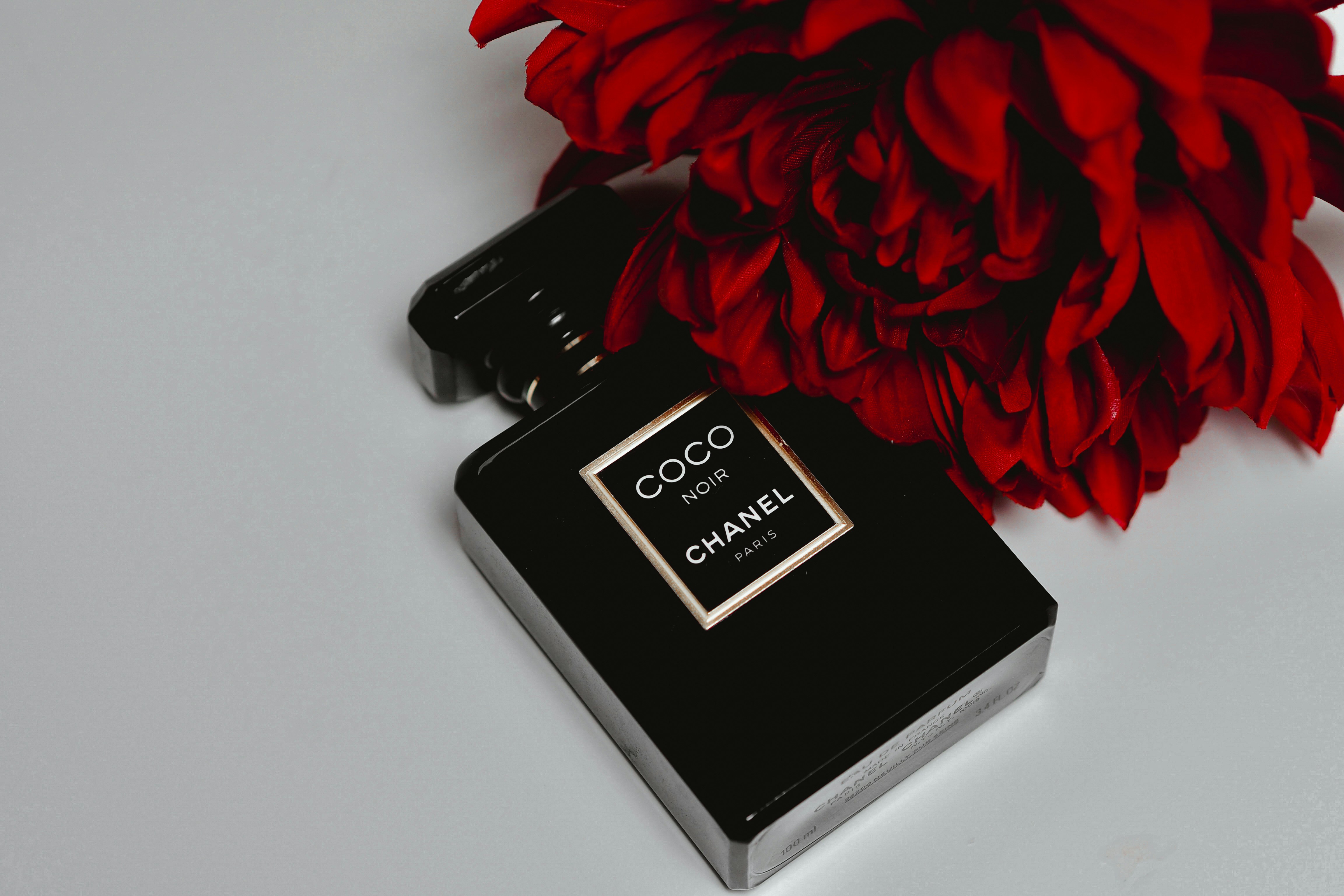 black and silver box beside red rose