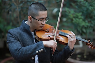 man in black coat playing violin