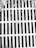 A metal grate with parallel bars covers a drain or opening. The surface appears weathered with debris and leaves scattered on top, suggesting an outdoor setting.