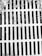 A metal grate with parallel bars covers a drain or opening. The surface appears weathered with debris and leaves scattered on top, suggesting an outdoor setting.