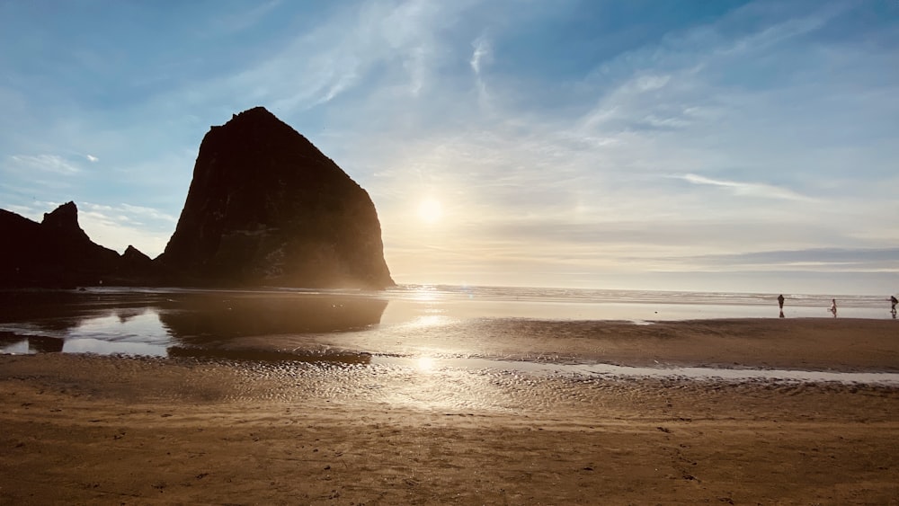 black rock formation on sea during daytime