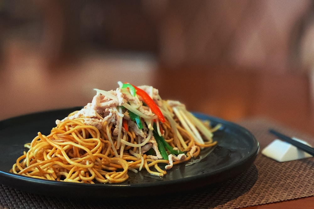 pasta dish on black plate