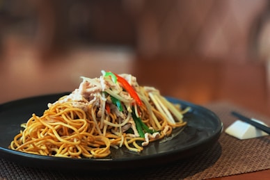 pasta dish on black plate