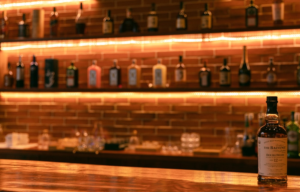 clear glass bottles on brown wooden shelf