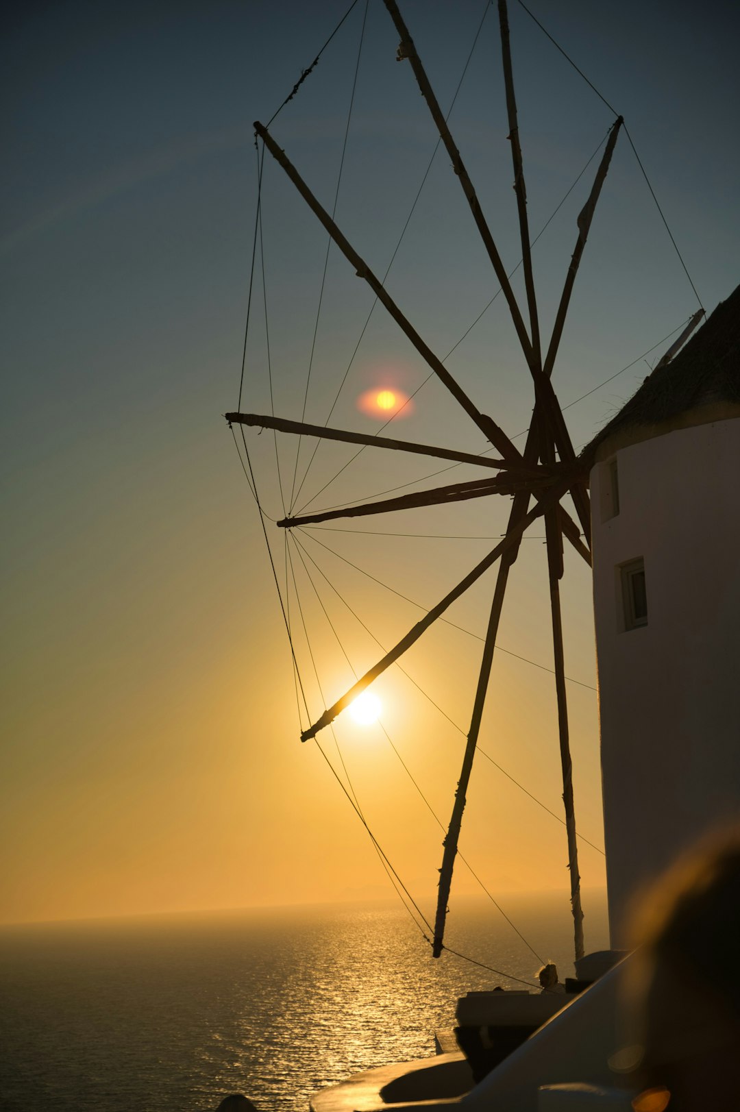 black wind mill during sunset