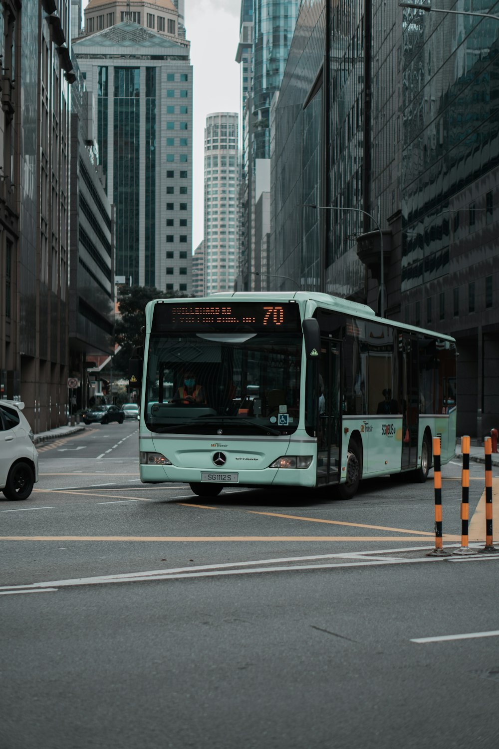 white bus on the road during daytime