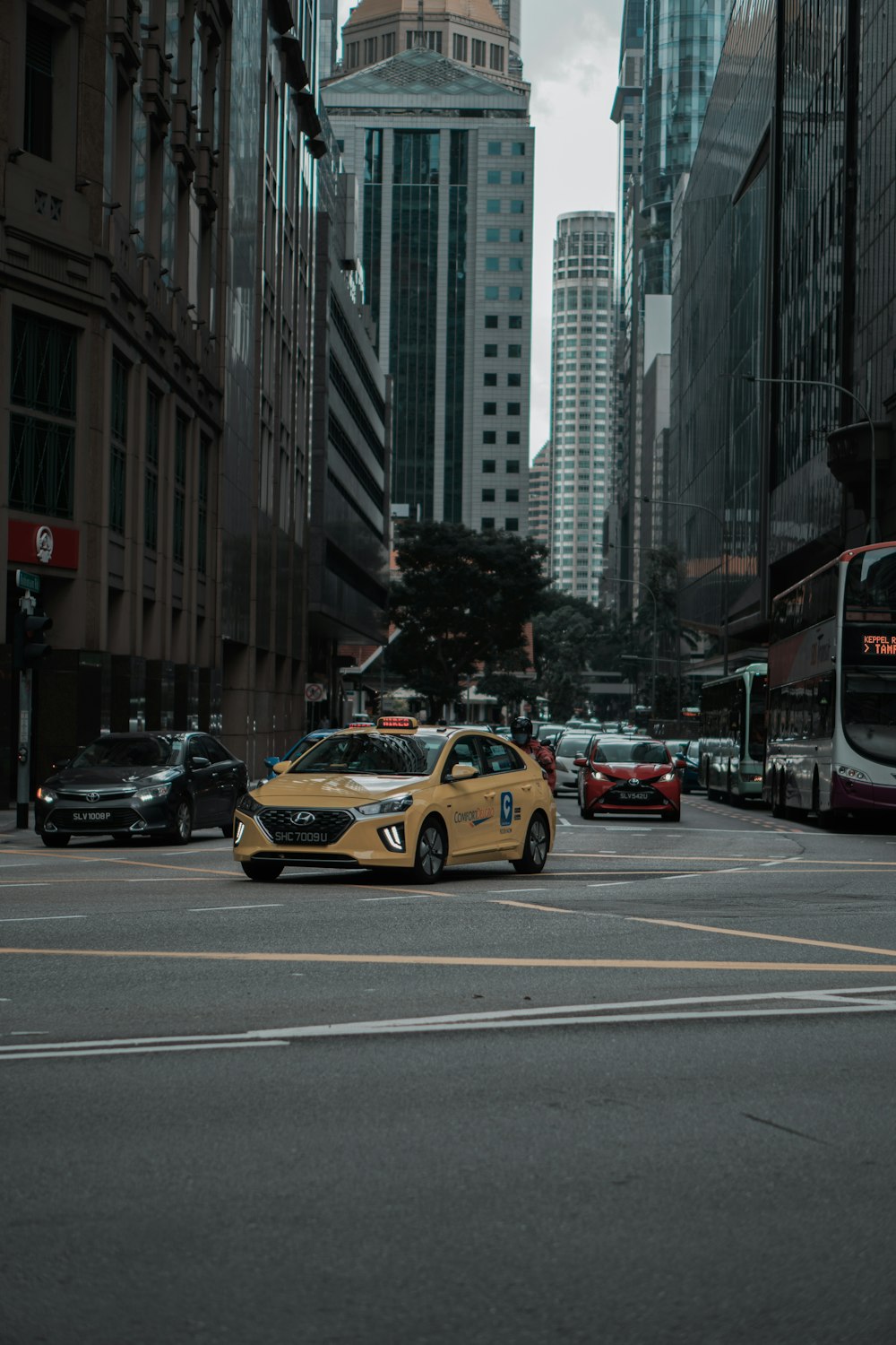 yellow taxi cab on the street during daytime