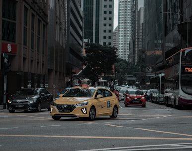 yellow taxi cab on the street during daytime