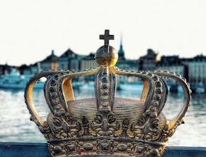 gold crown on blue body of water during daytime