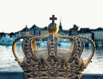 gold crown on blue body of water during daytime