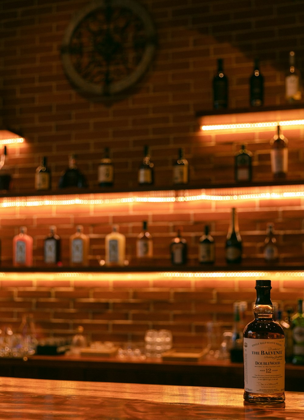 black and white bottles on brown wooden shelf