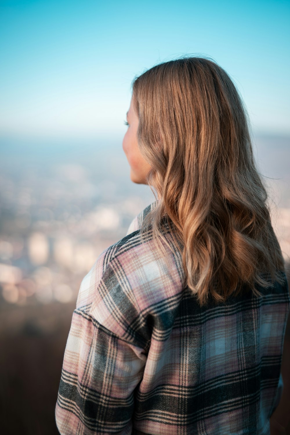 woman in white black and brown plaid shirt