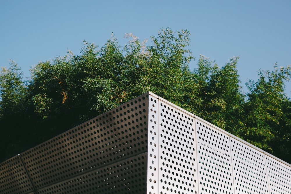 Bâtiment en béton blanc près d’arbres verts pendant la journée