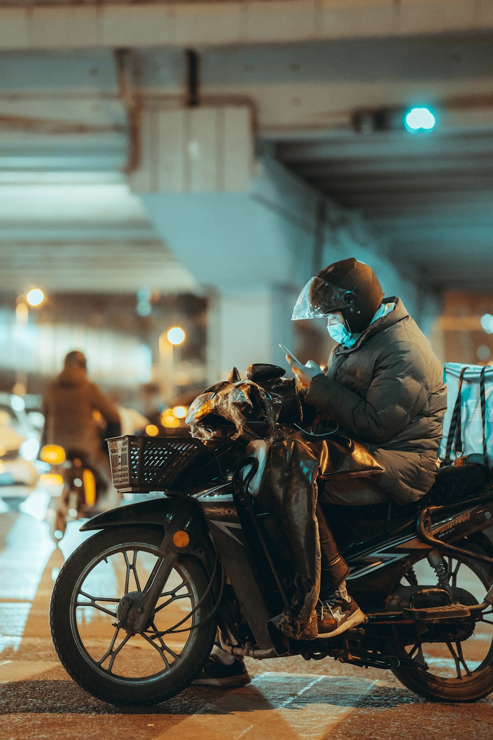 man in brown jacket riding on black motorcycle during night time